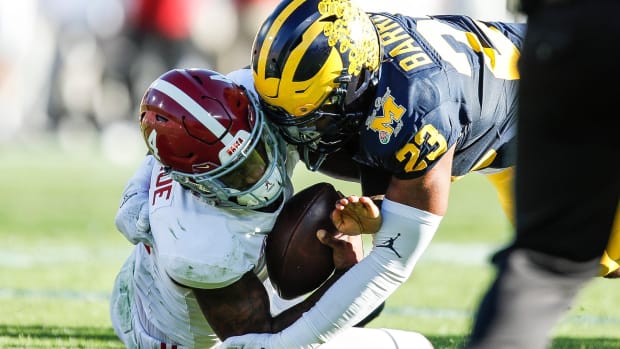 Rose Bowl: Michigan linebacker Michael Barrett tackles Alabama quarterback Jalen Milroe during the first half.